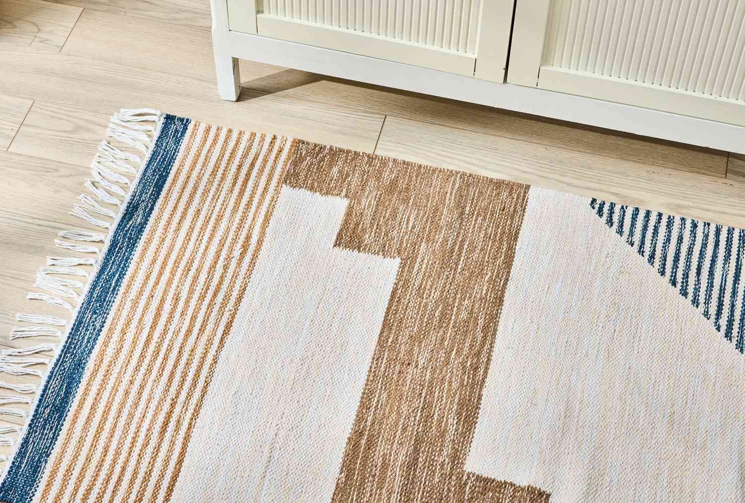 Flat-weave rug on wood floor