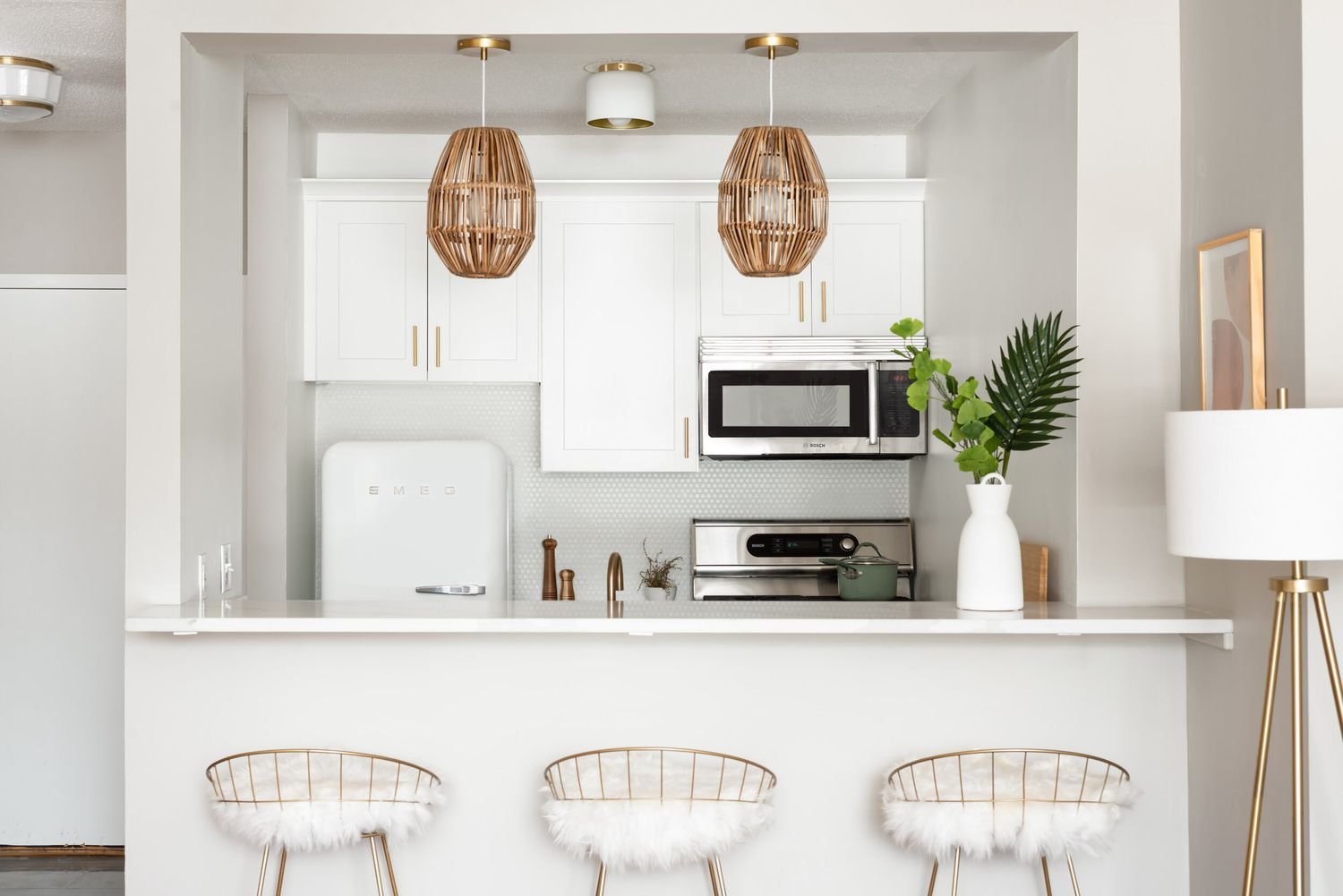 Mid century modern kitchen and bar in white and gold.