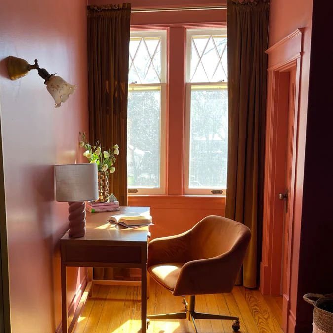 Moody coral paint color in small home office.