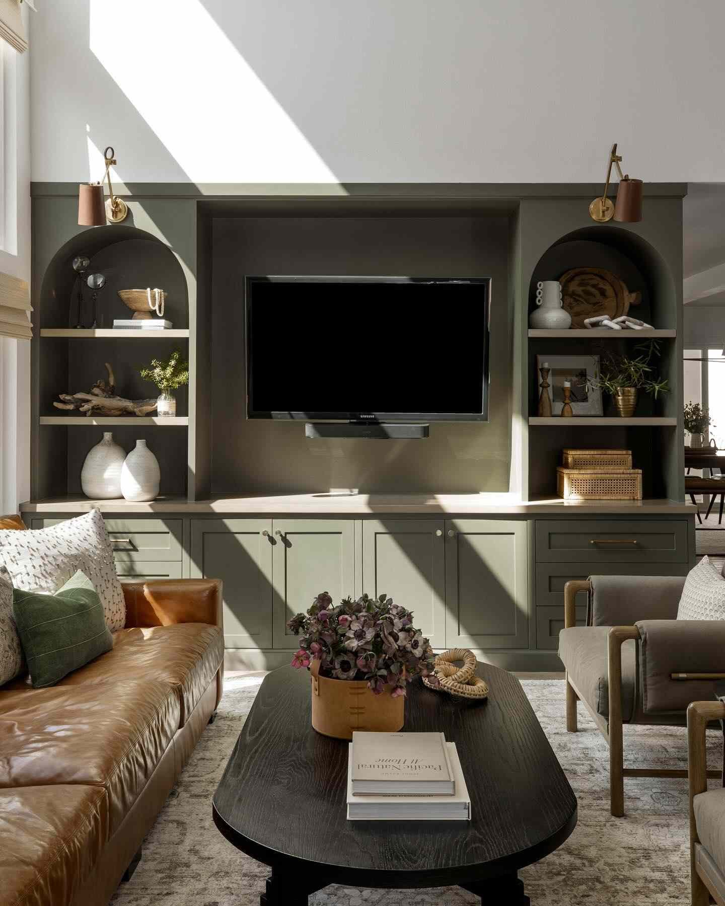 sage green living room with arched side built ins