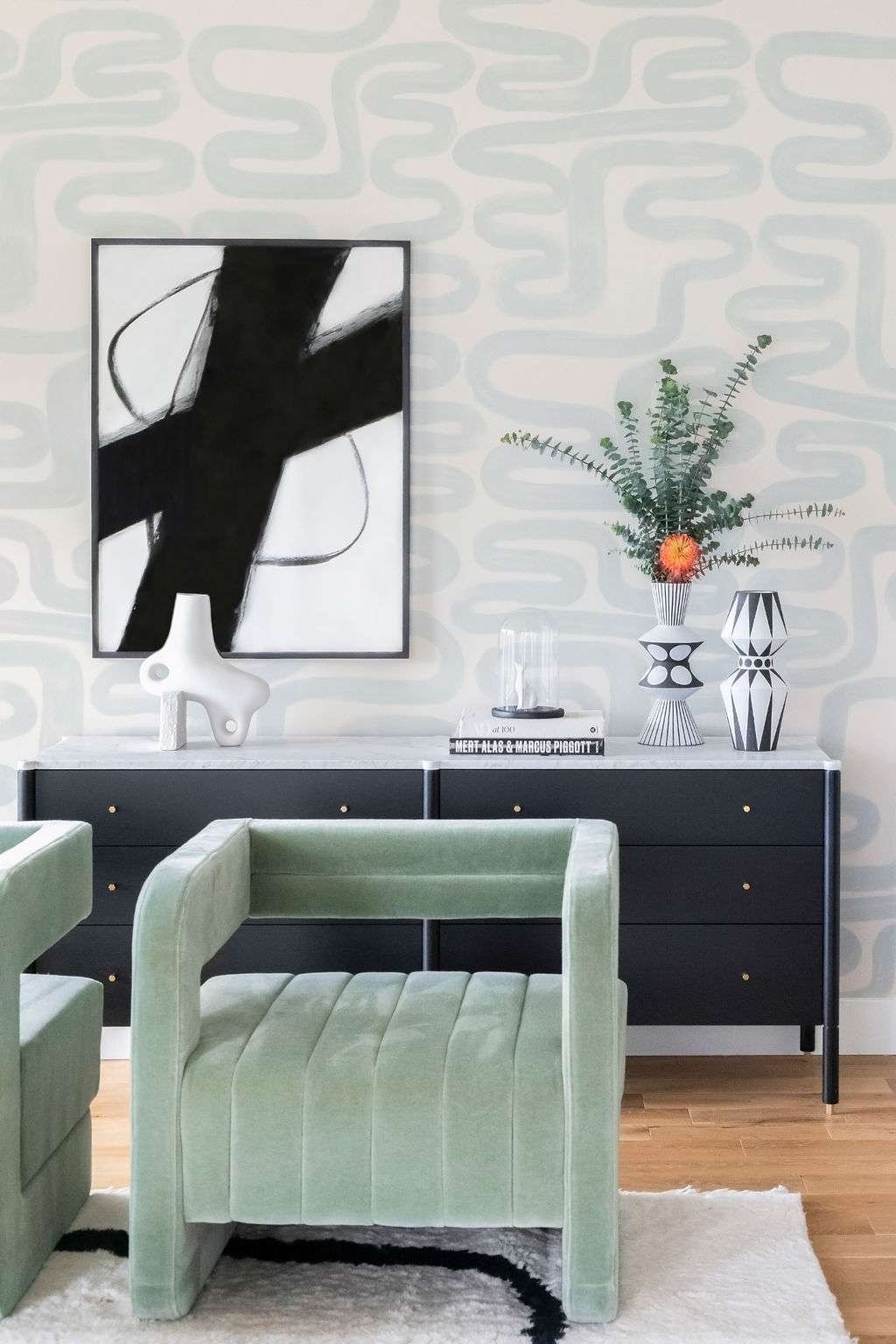 sage green chair and plant with black furniture and decor