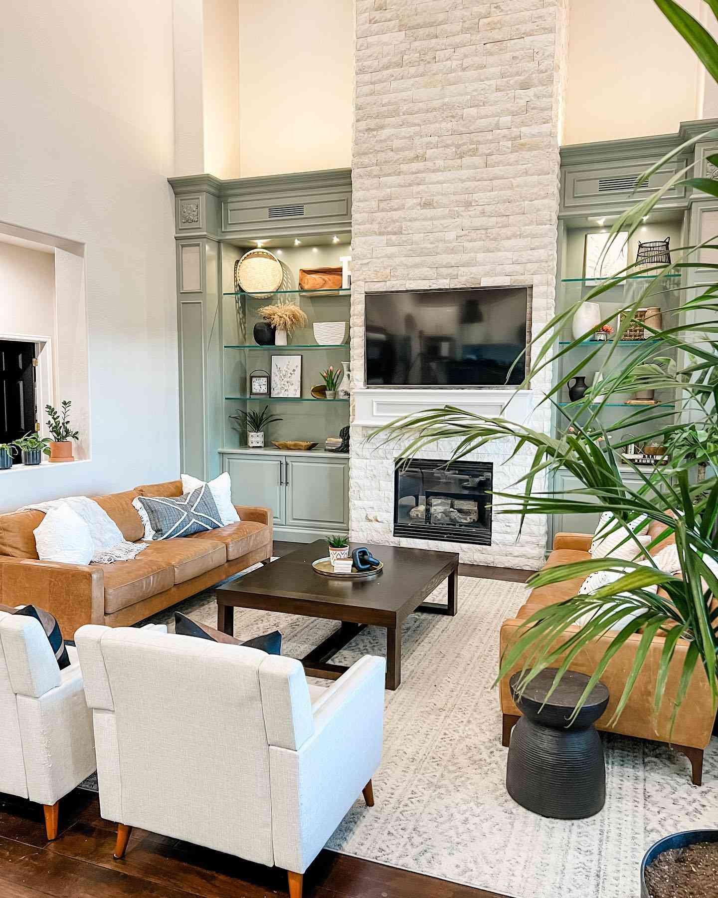white stone living room fireplace with sage green side built ins
