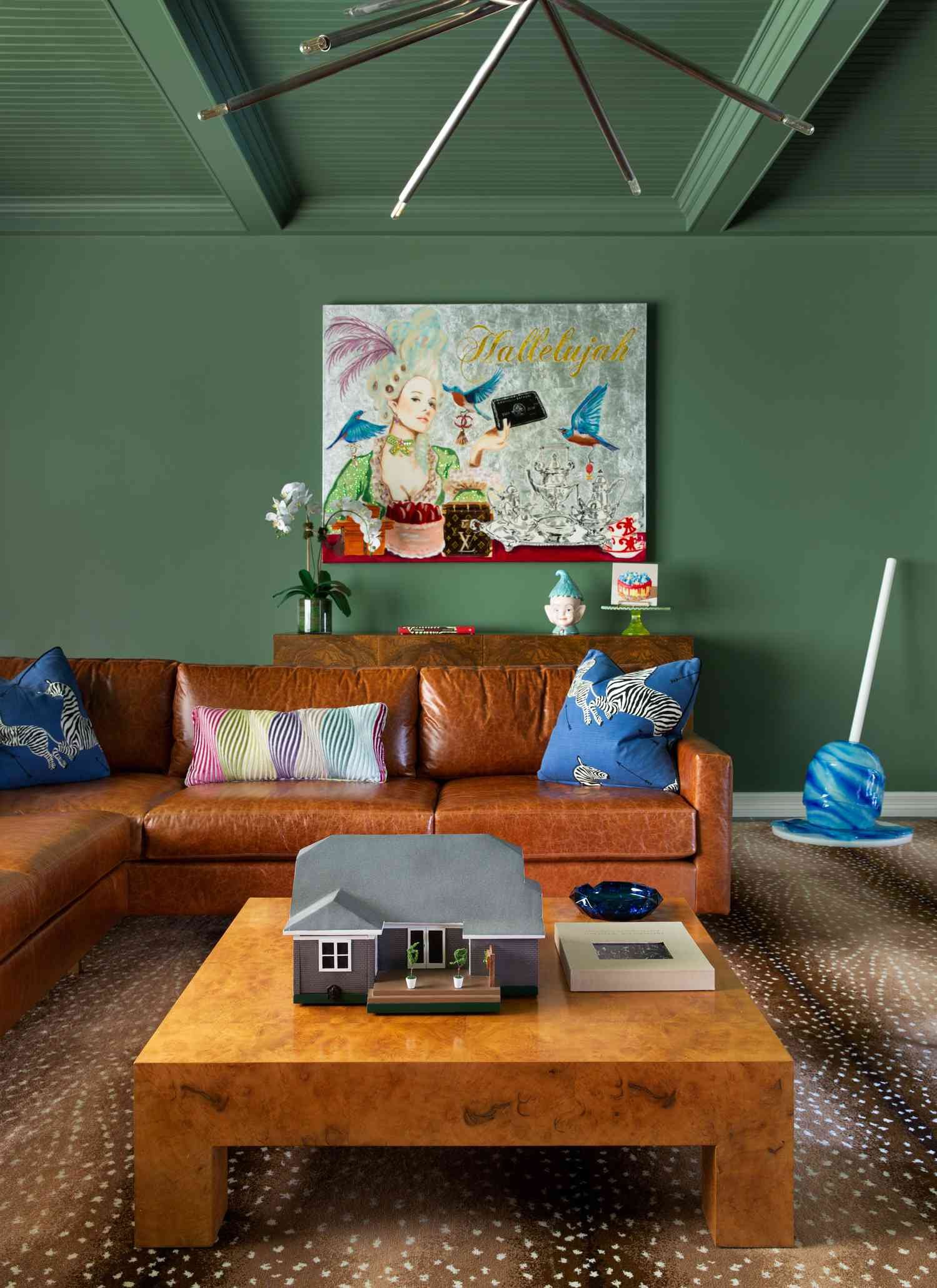sage green living room with modern chandelier