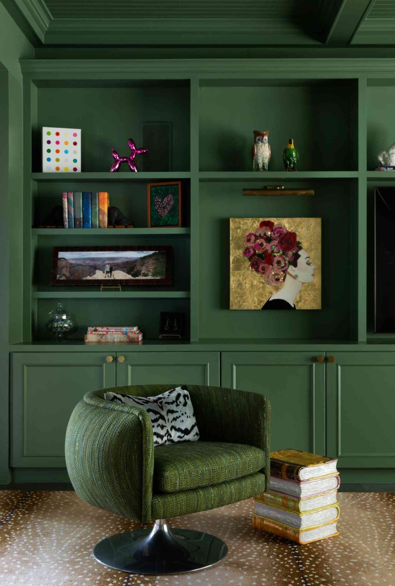 dark sage green living room with built in bookcase and bubble chair