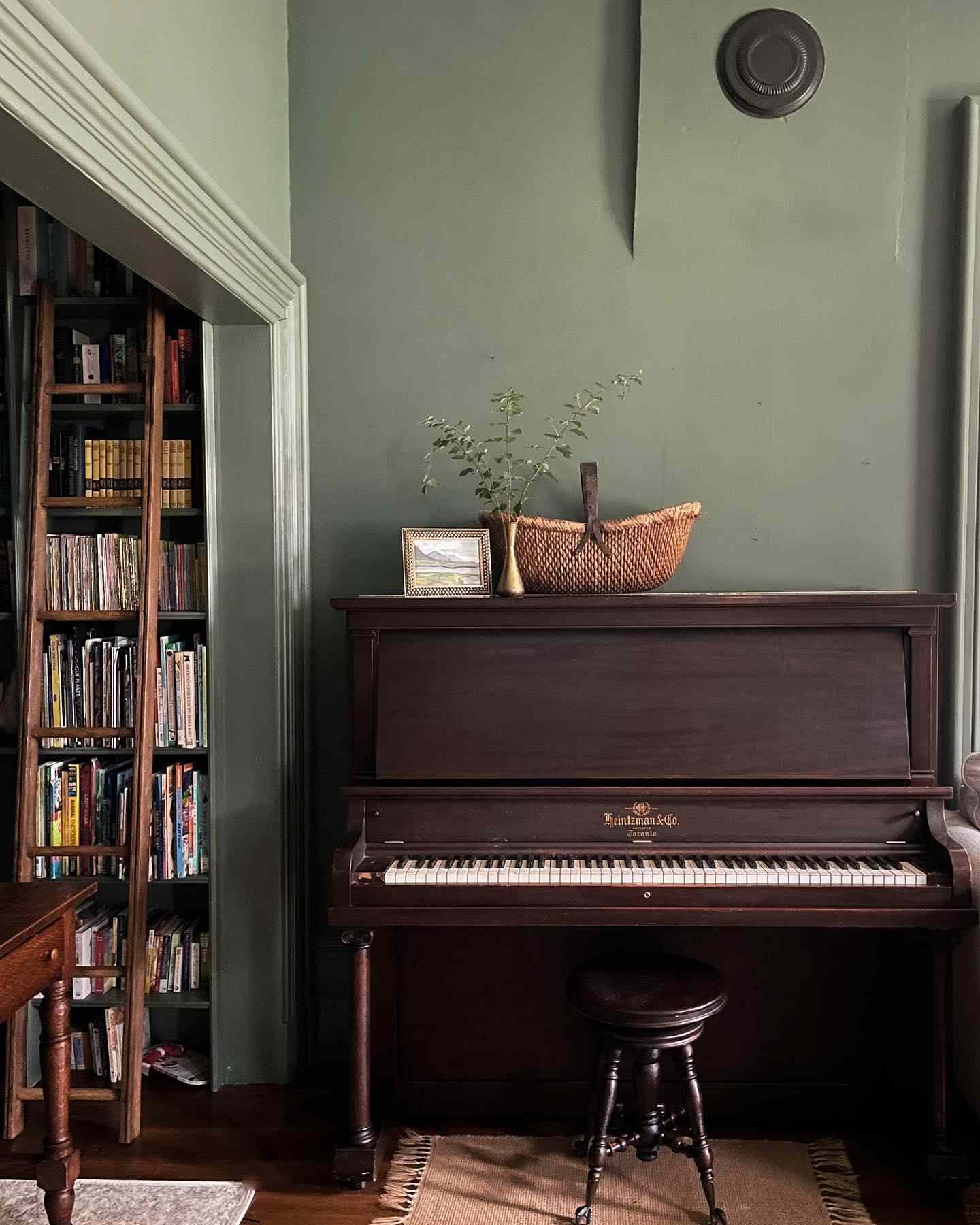 sage green living room wall with heritage piano