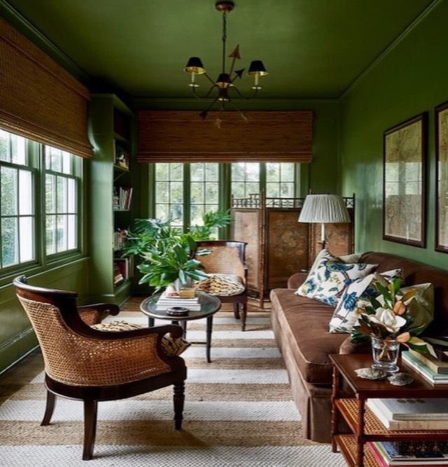 sage green sitting room with brown furniture