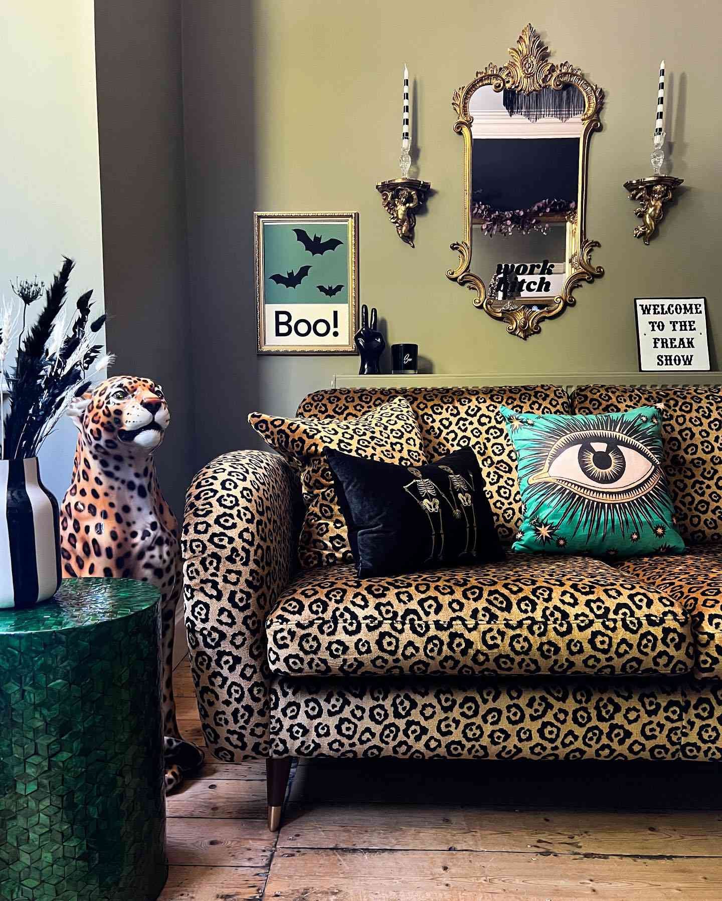 vibrant sage green living room with cheetah sofa