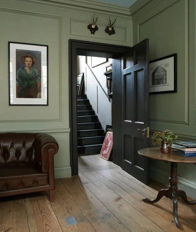 sage green living room with black trim and wall