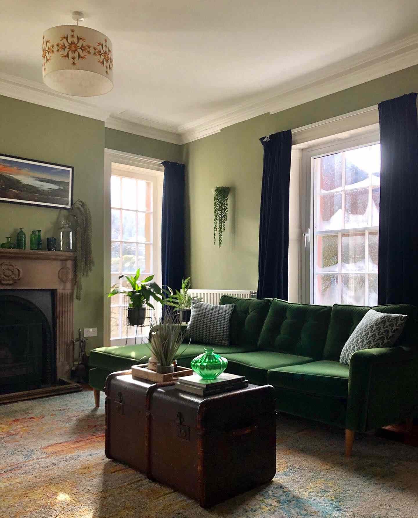 sage green living room with dark green curtains