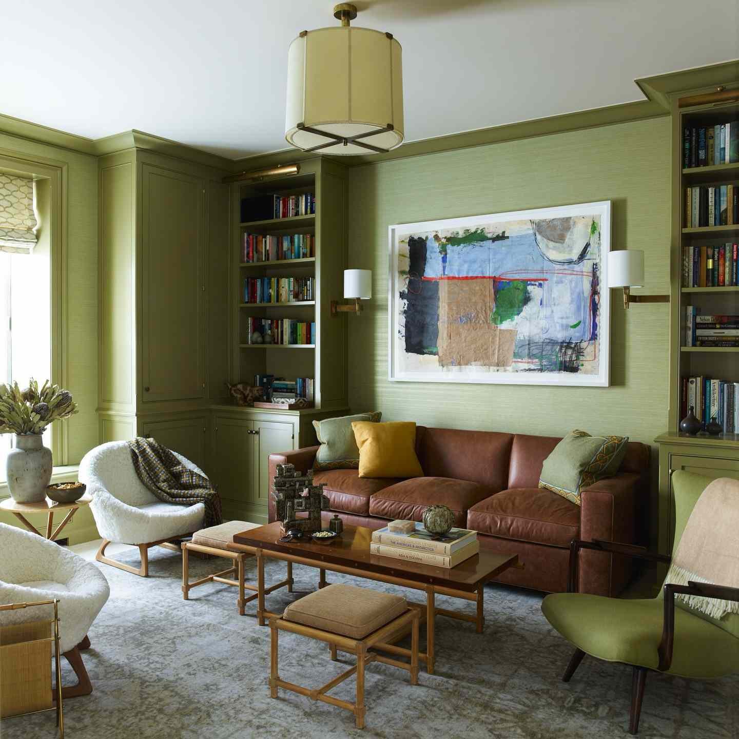sage green living room with warm leather sofa