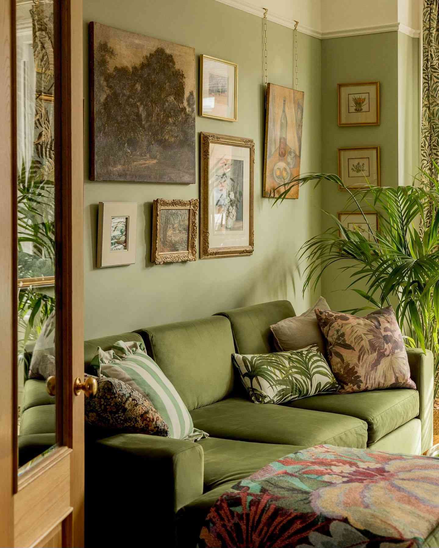 sage green living room with vintage gallery wall