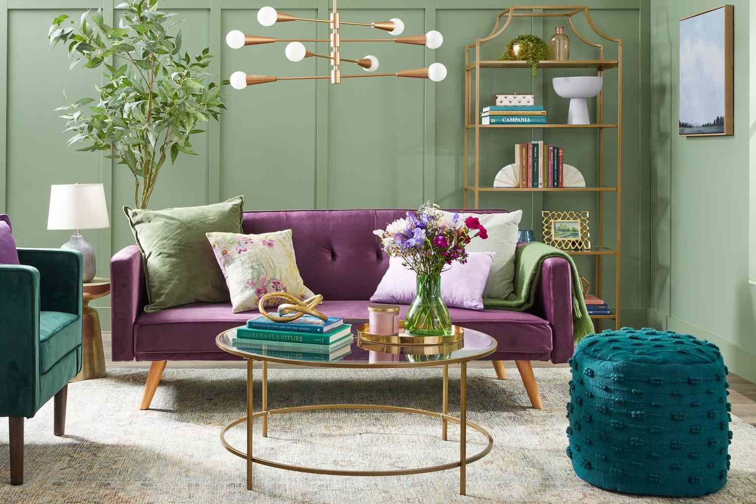 Front view of a living room with a purple sofa and accents of emerald green and sage