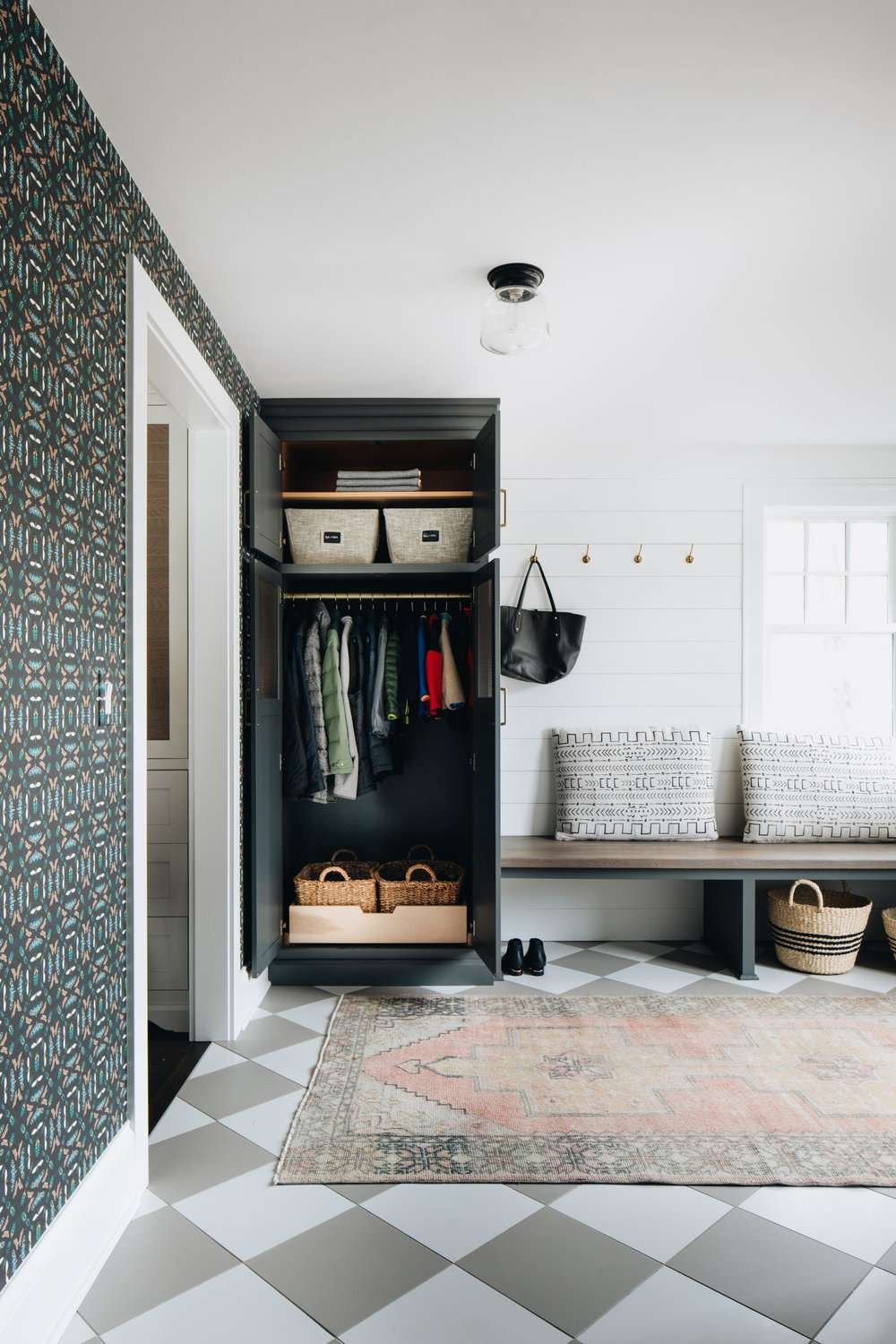 mudroom laundry room with wallpaper