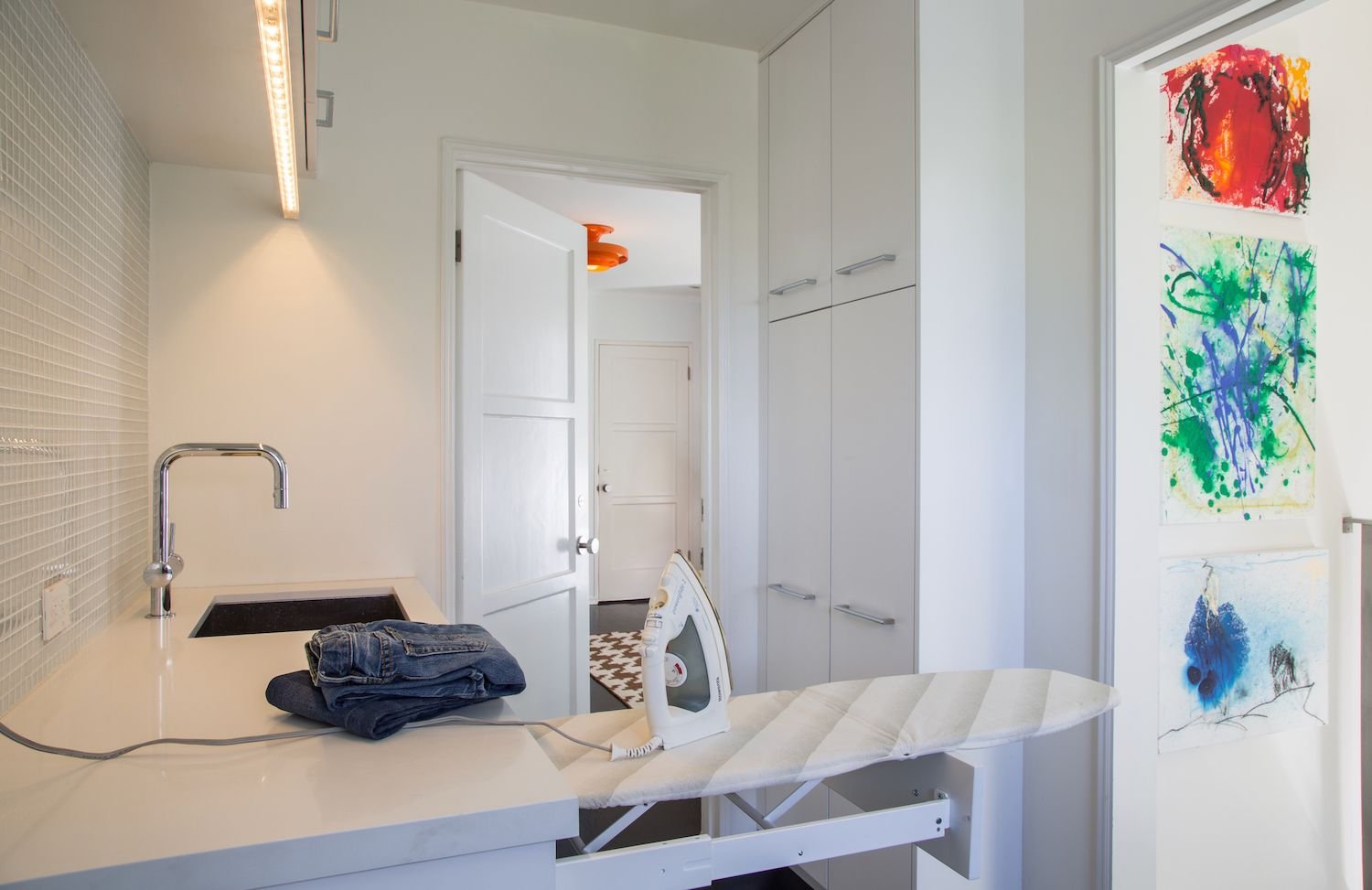 laundry room with built-in ironing board