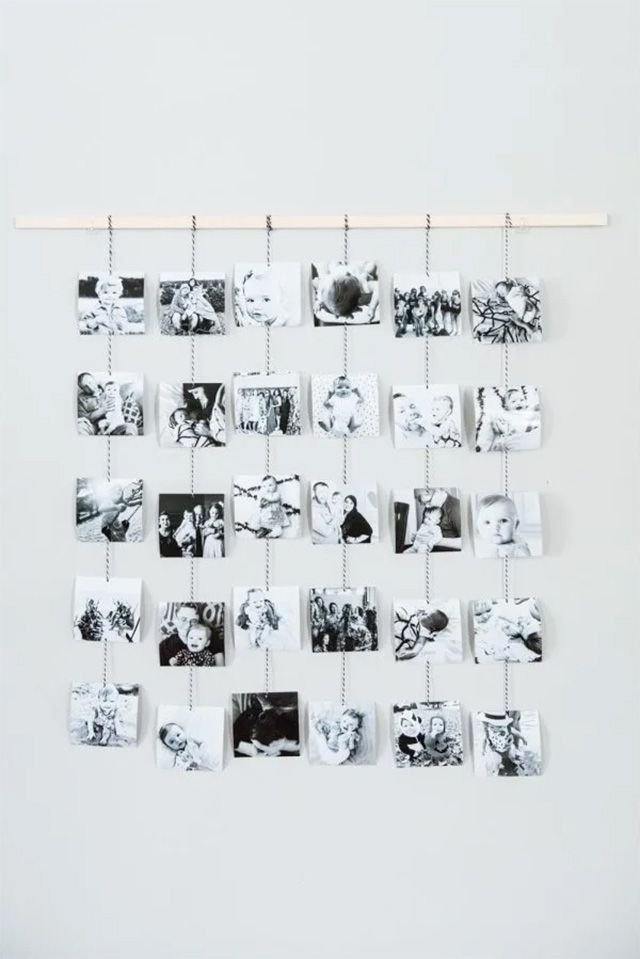 Black and white photos strung from a piece of wood