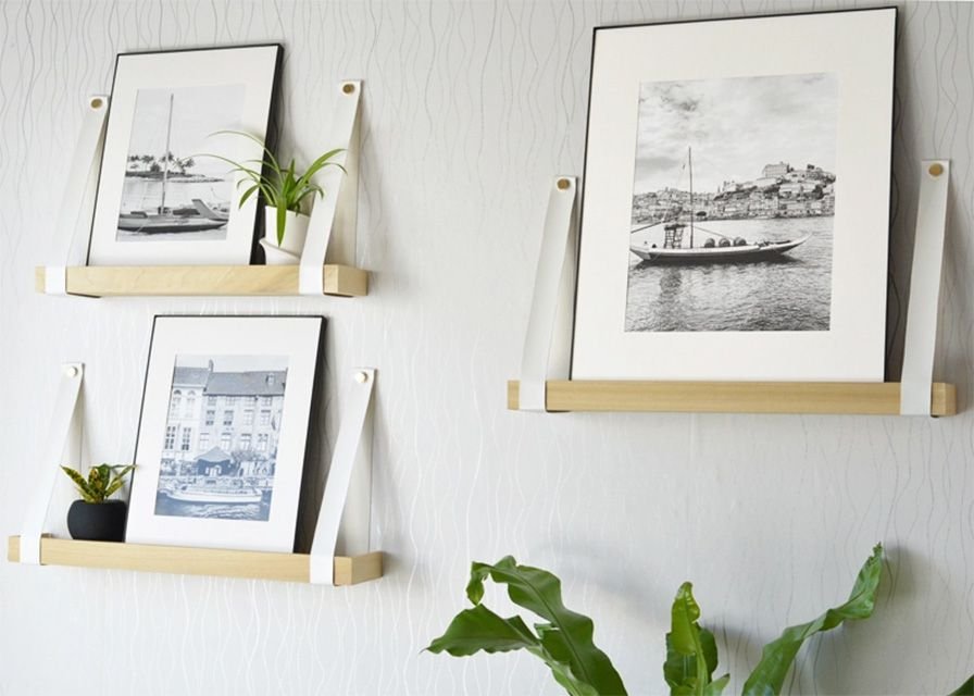 Leather and wooden art ledges hanging on the wall