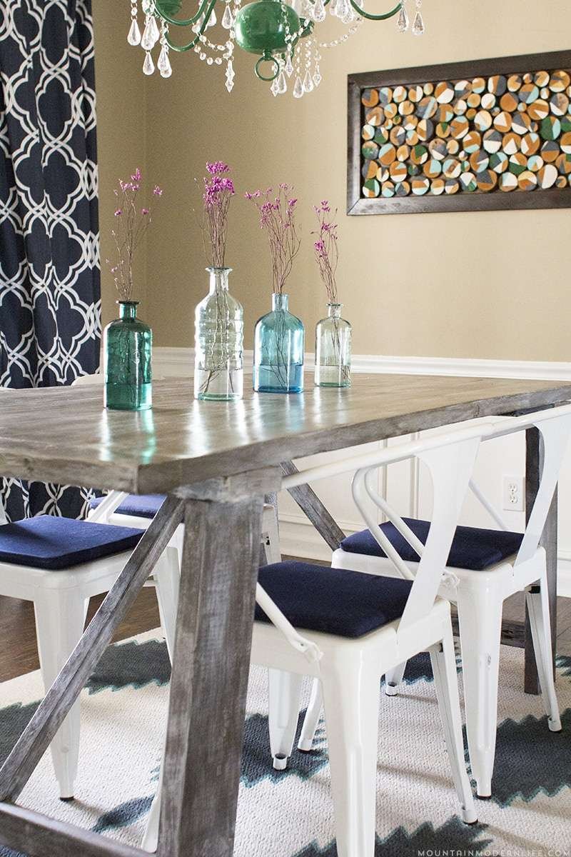 A painted rug under a dinging room table