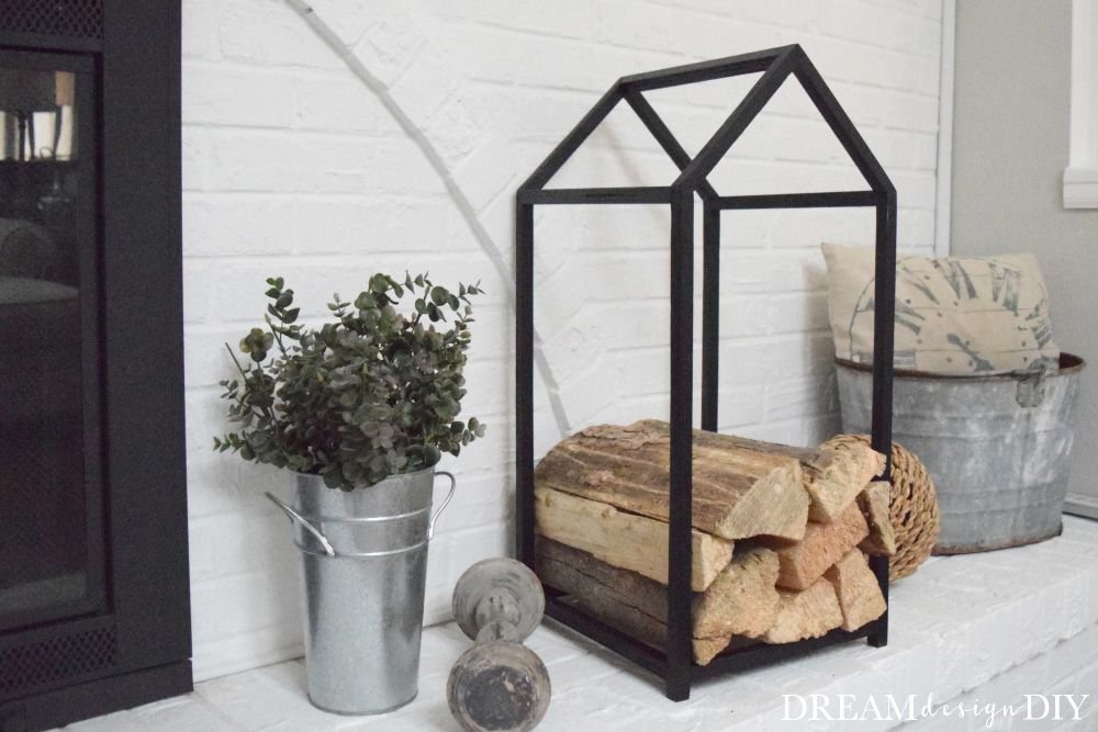 A black log holder on a hearth