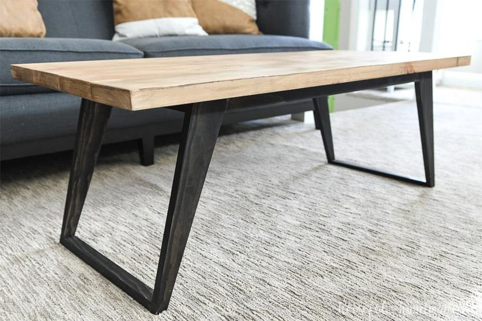 A wooden and black simple coffee table in a living room