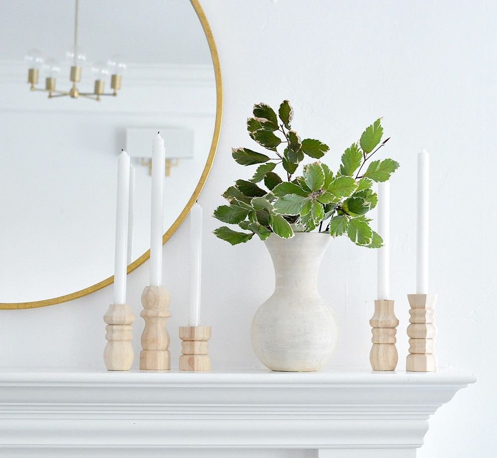 Candlesticks and a vase on a mantel