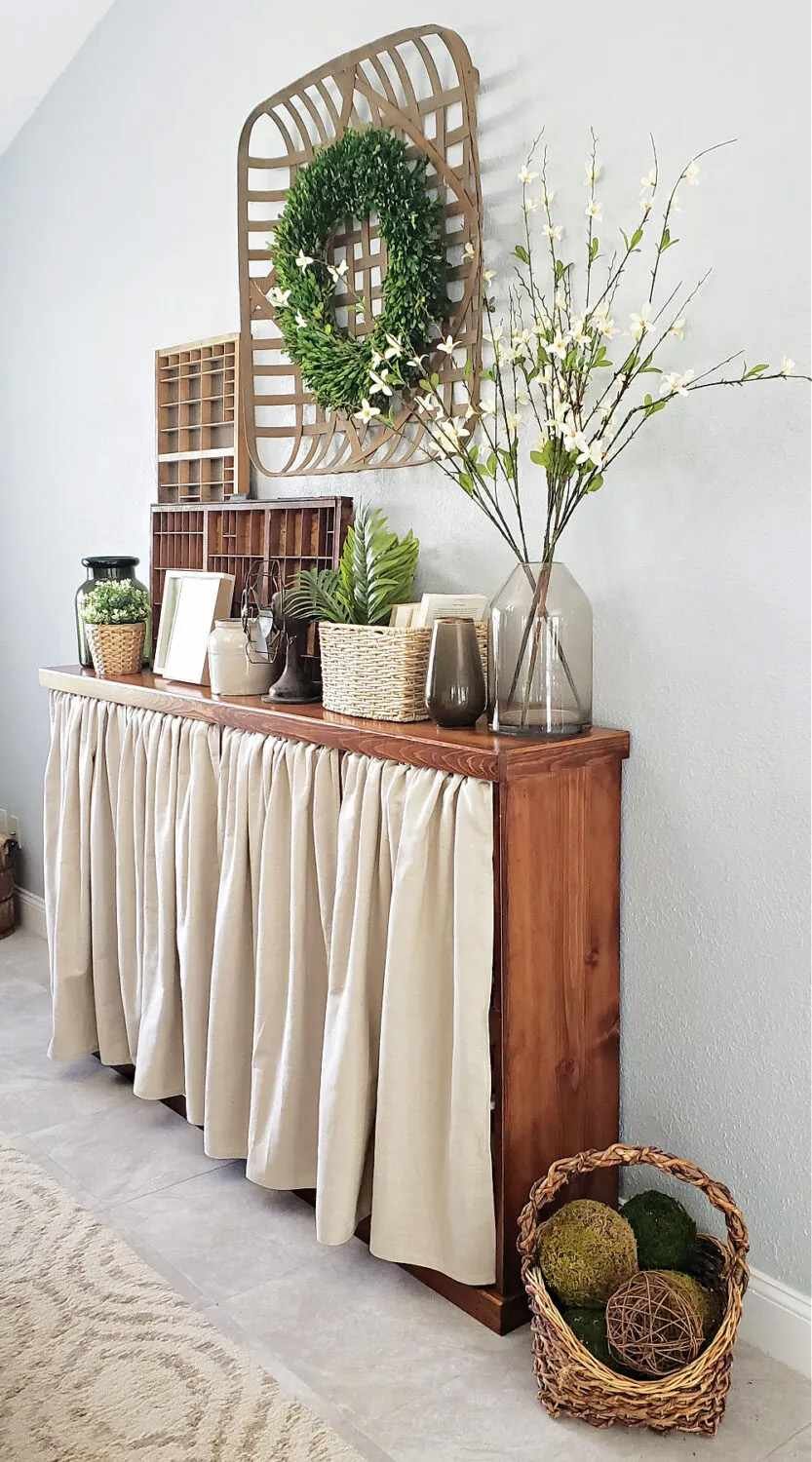 A wooden cabinet with a curtain
