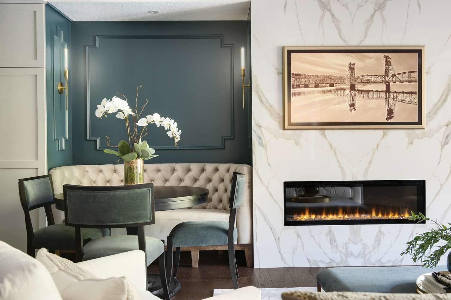 sage green seating nook with neutral tufted sofa