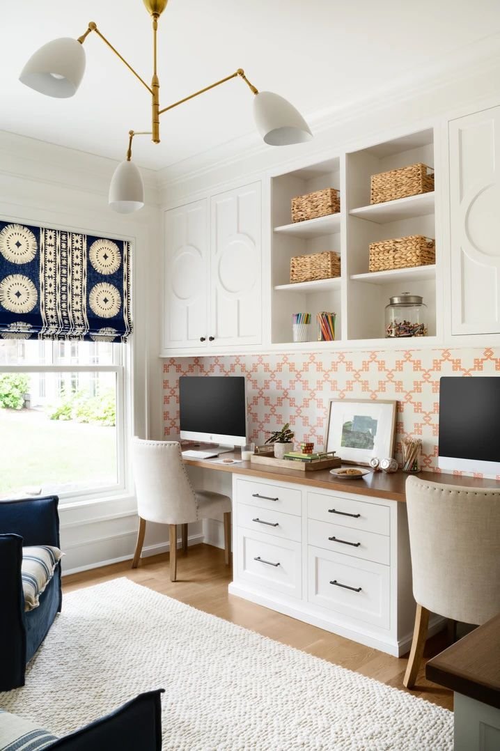 White and brass three-arm ceiling light in an office with white built-ins