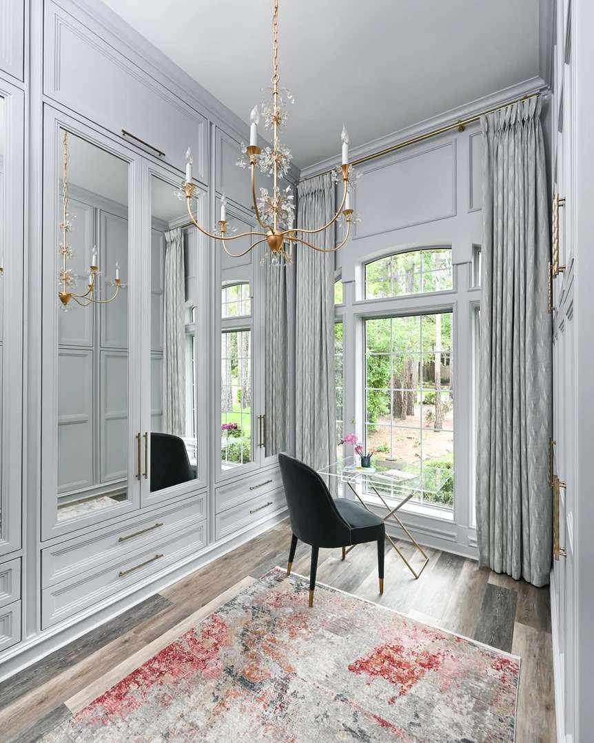Ornate candelabra chandelier in a home office that doubles as a closet