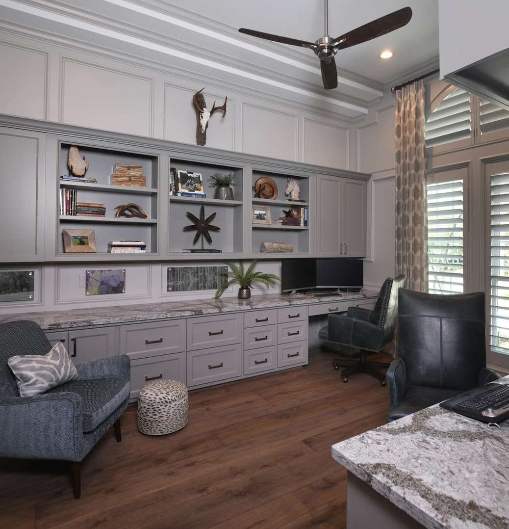Ceiling fan in a home office with floor to ceiling built-ins