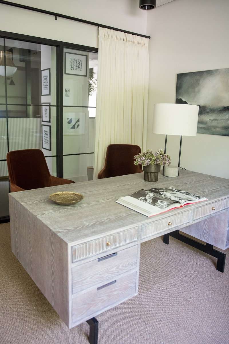 Table lamp with white shade on a modern desk in a home office