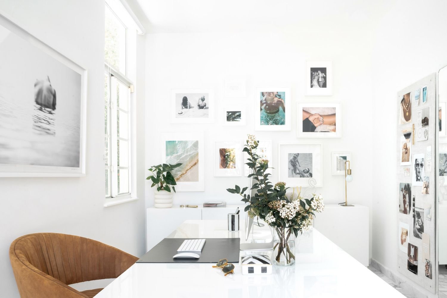 Brass table lamp with an exposed bulb on a white console in an office