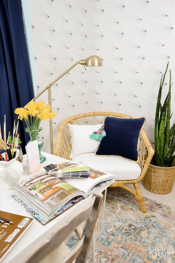 Brass floor lamp next to a rattan chair in an office