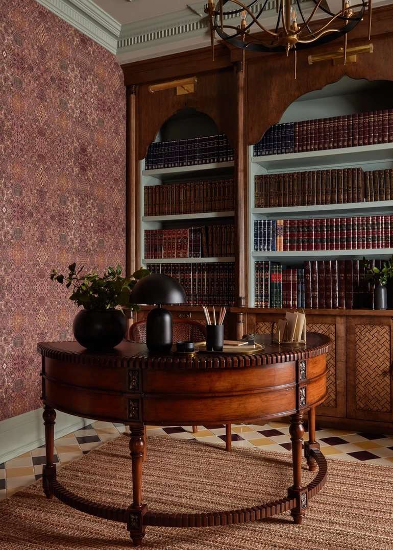 Brass picture lights on wood built-ins in a traditional home office